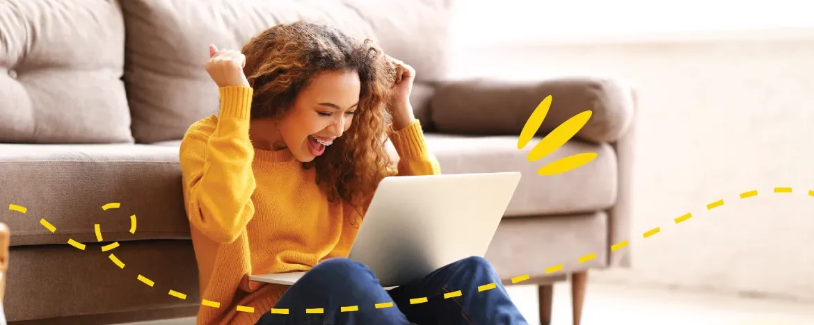 Woman celebrating with laptop