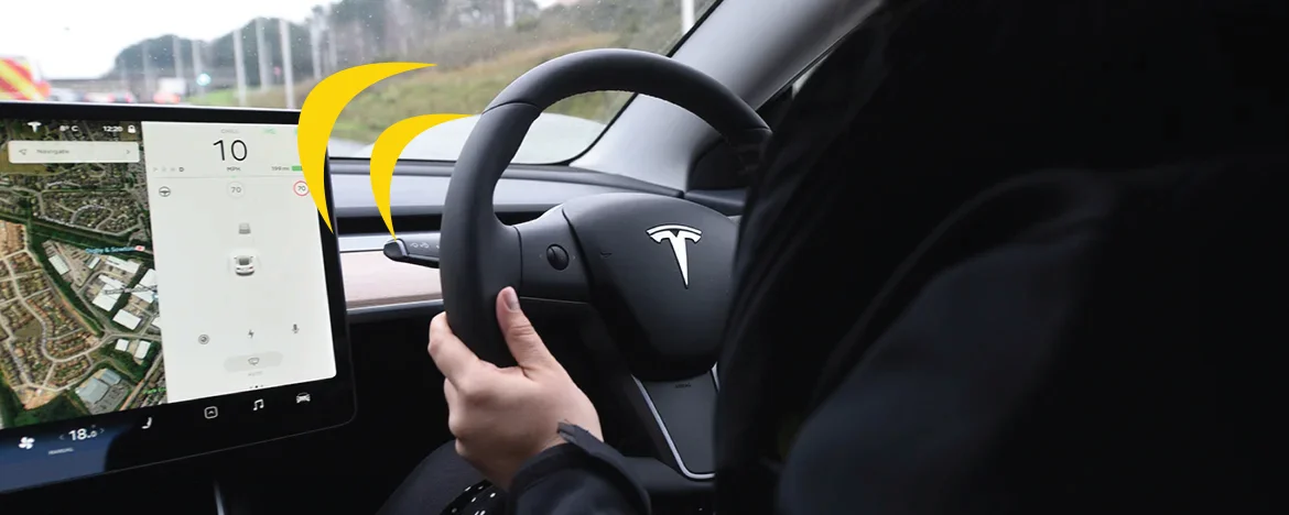 Someone driving a Tesla