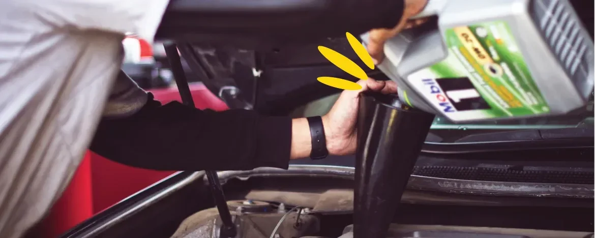 Person topping up engine fluid