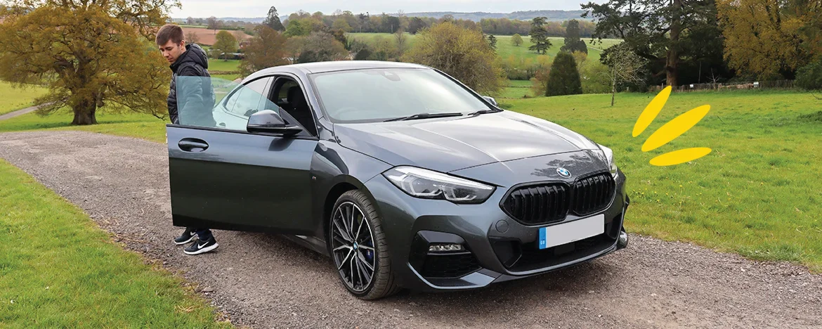 BMW 2 Series Gran Coupé parked up with person by it
