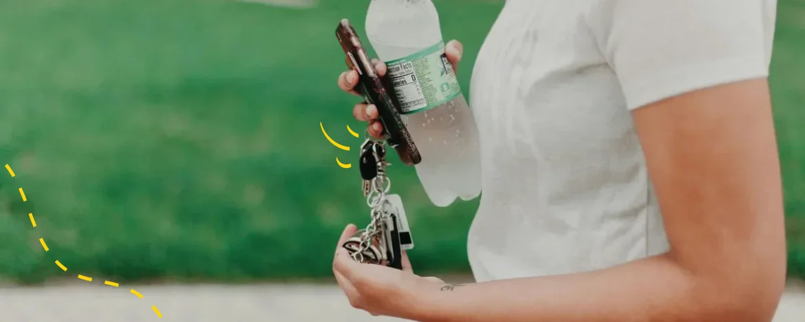 person holding water and keys