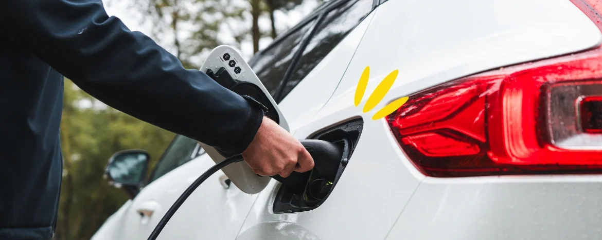 Man plugging an EV charger into an electric car