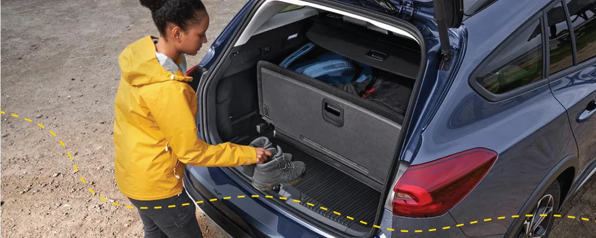 Lady putting boots into Ford Focus estate boot