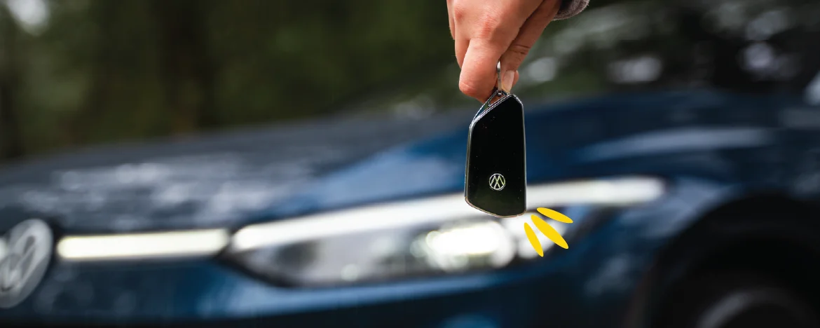 Hand holding keys in front of VW ID.5