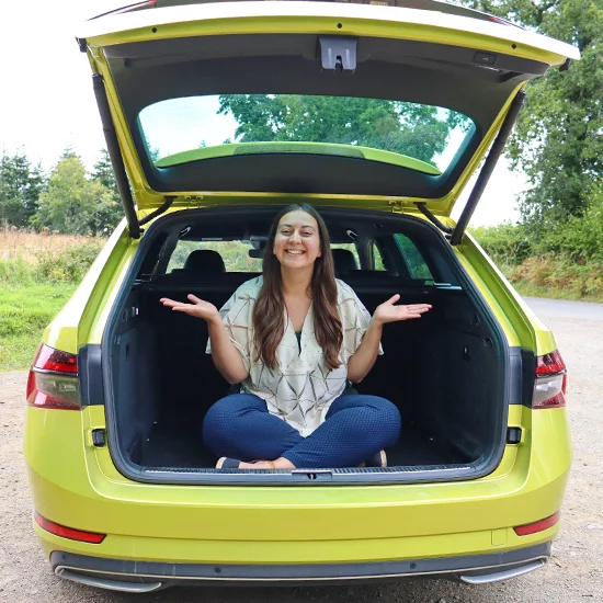 Woman sat in boot of Skoda Superb